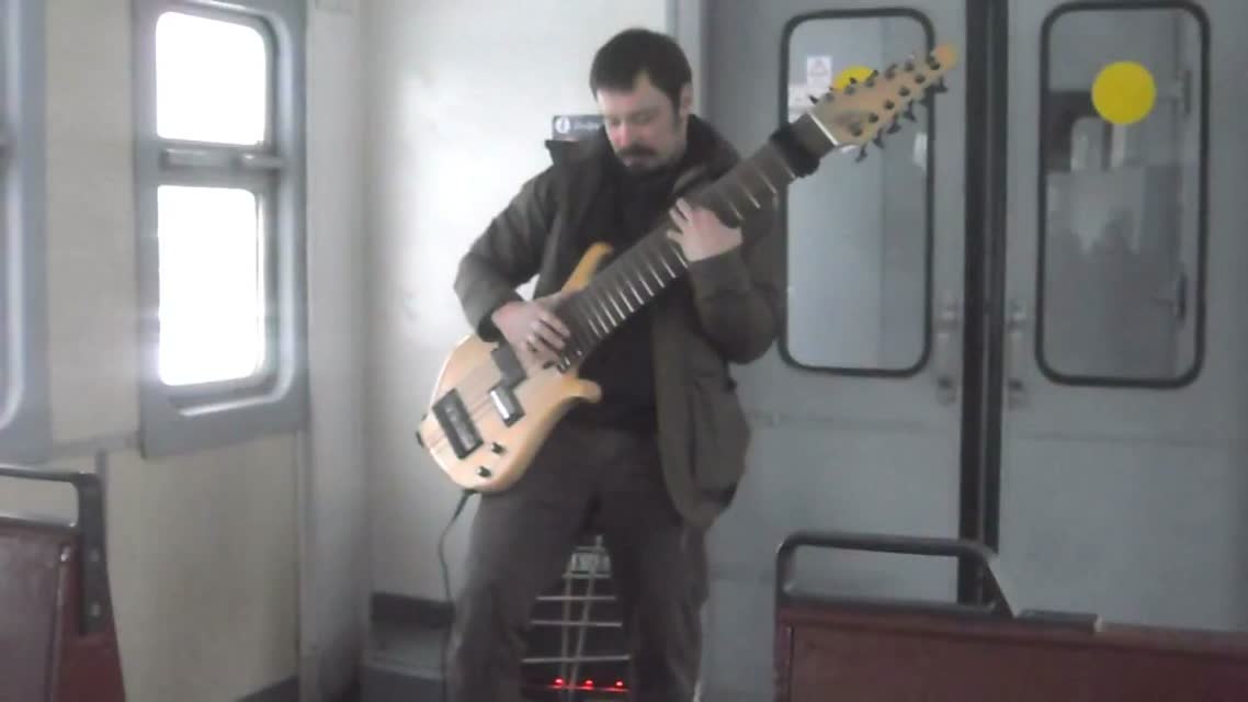 Гитарист музицирует на 12-струнной бас гитаре.