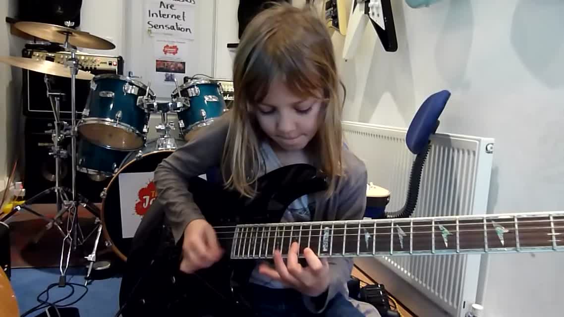 8_year_old_The_Mini_Band_guitarist_Zoe_Thomson_working_on_Stratosphere_by_Stratovarius